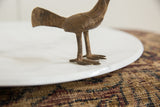 The handmade texture and vintage patina on the legs of the African bronze bird.