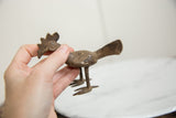 Textured body with rich patina on a handmade African bronze bird sculpture.