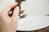 Hand-sculpted bronze bird feet showing aged patina and textured details.