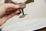 Handmade texture on the cast bronze legs and feet of a vintage African bird.