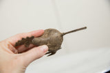 Top view of the vintage bronze bird showing incised concentric patterns and long tail.