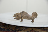 Textured surface of the handmade bronze chameleon with open mouth and coiled tail.