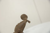 Vintage African bronze chameleon head featuring spiral design and textured scales.