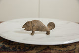 Vintage African bronze chameleon with detailed scales, a ridged back, and a spiral tail.