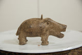 Vintage African bronze hippo in profile, showing its stout body and textured surface.