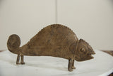 Vintage African bronze chameleon with its textured, arched back and coiled tail.