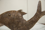 Vintage African bronze fish displaying concentric circle scales and rich, aged texture.