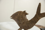 Curved scale texture and dark eye of the vintage African bronze fish.