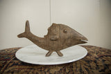 Profile view of a handmade bronze fish showing its etched scales and aged patina.