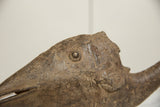Close-up of the vintage bronze fish's head with its rounded eye and etched scale patterns.