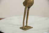 Detail of vintage African bronze bird's weathered long legs and webbed feet.