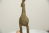 Aged bronze texture and intricate pattern on the vintage African bird's back.