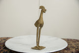 Side profile close-up of a vintage African bronze bird showing its detailed crest and textured patina.