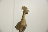 Detailed close-up of the vintage African bronze bird's textured head and fanned crest.