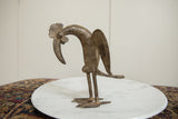 Side view of the vintage African bronze bird's stylized form and curved neck.