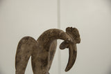 Detailed view of the vintage bronze bird's head with scrolled comb and aged patina.