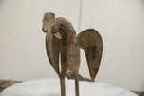 Back profile of a vintage African bronze bird, showing the aged patina and shape of the wings.
