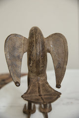 Hand-etched crosshatch details on the back and spread wings of an African bronze bird.