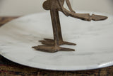 The vintage African bronze bird's textured, splayed feet and slender legs.
