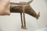 Vintage African bronze warthog held to show its profile and textured, aged patina.
