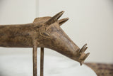 Detailed profile of the vintage bronze warthog's head with its hand-carved eye and tusks.