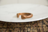 Side view of the antique copper snake bracelet, highlighting its aged patina and texture.