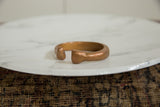 The solid, sculptural profile of the hand-forged antique African copper bracelet.