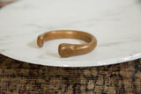 Smooth, curved form and warm patina of the antique African copper bracelet cuff.