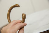 Close-up of the copper bracelet's hand-formed terminal showing its antique patina.