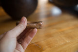 Finely crafted snake head detail with dotted eyes on an antique copper bracelet.