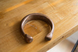 Antique African copper cuff showing its substantial form and naturally aged patina.