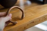 Handmade details of the antique copper snake cuff's open design and stylized end.