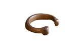 Antique African copper snake cuff bracelet with a stylized open design and aged patina.