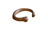 Antique African copper snake cuff bracelet with a handcrafted form and time-softened patina.