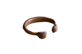 Antique African copper snake cuff bracelet with a hand-forged body and a rich, aged patina.