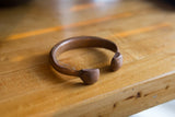 Aged patina on the hand-crafted, open ends of the antique copper snake cuff.