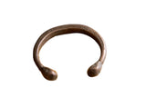 Antique African copper snake cuff bracelet with etched geometric details and a dark aged patina.