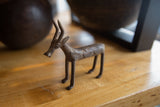 Collector's vintage bronze antelope, close-up of etched patterns and curved horns.
