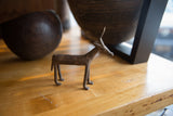Textured body and slender legs of the vintage bronze antelope.