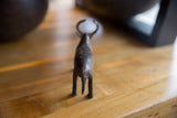 Rear view of the vintage African bronze zebu showing its rustic, handmade texture.