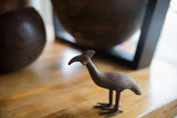 The textured body and unique profile of a vintage bronze bustard bird.