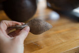 The cross-hatched, hand-carved texture on the back of the African bronze bird.
