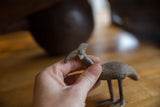 Vintage Kori bustard bird held in hand, showing its handmade texture and scale.