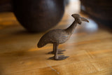 Detailed view of the vintage African bronze kori bustard bird's textured head and neck.
