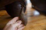Vintage African bronze Kori Bustard bird's textured body with etched lines.