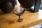 Handmade African bronze bird sculpture head with flat bill and textured surface.