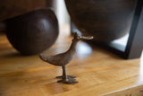 Stylized vintage African bronze bird sculpture showing its rich, dark aged patina.