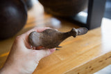 Angled view of the vintage bronze bird, highlighting its elongated shape and rustic texture.