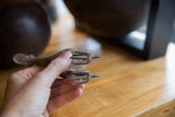 The textured, forked feet of the handmade African bronze bird, viewed from below.