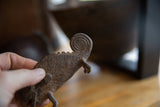 Vintage African bronze chameleon: dark patina, textured back, and coiled head.